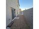 Side yard with rock landscaping, block wall, and access to the sliding glass door at 10265 Franford Ct, Las Vegas, NV 89183