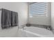 Relaxing bathroom with soaking tub and granite accents at 10440 Irish Cliffs Ct, Las Vegas, NV 89149