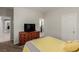 Bedroom with dresser, TV, and access to other rooms at 10440 Irish Cliffs Ct, Las Vegas, NV 89149