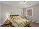 Bright bedroom with yellow bedding and a comfortable armchair at 10440 Irish Cliffs Ct, Las Vegas, NV 89149