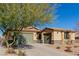 Single-story house with double garage and a landscaped front yard at 10440 Irish Cliffs Ct, Las Vegas, NV 89149