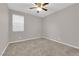 Neutral bedroom features plush carpeting, a ceiling fan, and a window at 4529 Swimming Minnow Ave, Las Vegas, NV 89141