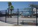 Aquatic center featuring a waterslide and recreational area, secured by a tall black fence at 4709 W Alpine Pl, Las Vegas, NV 89107
