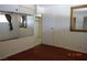 Bedroom with wood floors, large mirror, and a closet with shelving at 4709 W Alpine Pl, Las Vegas, NV 89107
