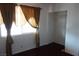 Bedroom with wood floors, window with curtains, and closet at 4709 W Alpine Pl, Las Vegas, NV 89107