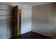 Bedroom featuring dark wood floors, closet, and wood paneling at 4709 W Alpine Pl, Las Vegas, NV 89107