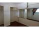 Bedroom with wood floors, large mirror, and multiple closet spaces at 4709 W Alpine Pl, Las Vegas, NV 89107