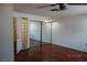 Bedroom with hardwood floors and mirrored closet at 4709 W Alpine Pl, Las Vegas, NV 89107