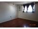 Bright bedroom with hardwood floors, window, and shelving at 4709 W Alpine Pl, Las Vegas, NV 89107