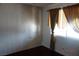 Bedroom featuring wood floors, wood paneling, and window with drapes at 4709 W Alpine Pl, Las Vegas, NV 89107