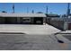 Exterior showcasing the front with a carport, geometric block accents, and a concrete driveway at 4709 W Alpine Pl, Las Vegas, NV 89107