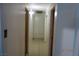 Hallway featuring tile flooring, white walls, and a storage cabinet at 4709 W Alpine Pl, Las Vegas, NV 89107