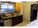 Compact kitchen featuring stainless steel appliances, granite countertops, and stylish tile flooring at 4709 W Alpine Pl, Las Vegas, NV 89107
