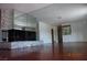 Spacious living room featuring a stone fireplace, mirrored wall, and gleaming hardwood floors at 4709 W Alpine Pl, Las Vegas, NV 89107