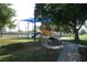 Community playground with a blue shade structure near park benches and a grassy area at 4709 W Alpine Pl, Las Vegas, NV 89107