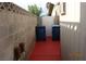 Side yard featuring painted concrete, block walls, and trash receptacles at 4709 W Alpine Pl, Las Vegas, NV 89107