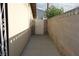 Side yard with a concrete path enclosed by a block wall and metal gate at 4709 W Alpine Pl, Las Vegas, NV 89107