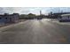 Street view of the property with a wide street and commercial buildings in the background at 4709 W Alpine Pl, Las Vegas, NV 89107