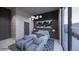 Bedroom featuring a bed with two grey chairs and modern side tables at 495 Cityview Ridge Dr, Henderson, NV 89012