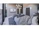 Bedroom featuring a bed with two grey chairs, modern lighting and a tv screen at 495 Cityview Ridge Dr, Henderson, NV 89012