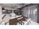 Elegant dining area with a long wooden table, wine storage, and contemporary lighting fixtures at 495 Cityview Ridge Dr, Henderson, NV 89012