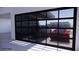 Showcasing a modern garage door with glass panels, partially revealing two parked cars and the home's exterior at 495 Cityview Ridge Dr, Henderson, NV 89012