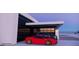 View of a home with a glass garage door revealing a red sports car and a black SUV, showcasing modern design elements at 495 Cityview Ridge Dr, Henderson, NV 89012