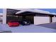 Contemporary home featuring a glass garage door, a red sports car and a black SUV parked on a clean driveway at 495 Cityview Ridge Dr, Henderson, NV 89012