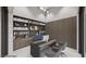 Well-appointed home office featuring custom bookshelves, a sleek desk, and comfortable seating at 495 Cityview Ridge Dr, Henderson, NV 89012