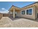 View of the home's backyard featuring a covered patio, and a block fence under a bright blue sky at 104 Barkset Way, Henderson, NV 89011