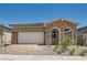 Charming single-story home featuring stone accents, desert landscaping, and a two-car garage at 104 Barkset Way, Henderson, NV 89011