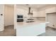 Modern kitchen featuring white cabinets, stainless steel appliances, and a large center island at 104 Barkset Way, Henderson, NV 89011