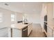 Contemporary kitchen with an island, stainless steel sink, and open view to the living area at 104 Barkset Way, Henderson, NV 89011
