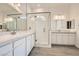 Elegant bathroom with dual sinks, a frameless glass shower, and modern fixtures at 104 Barkset Way, Henderson, NV 89011