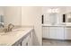 Stylish bathroom featuring dual sinks with stone countertops and white cabinetry at 106 Barkset Way, Henderson, NV 89011