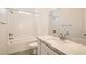 Bright bathroom featuring single sink, stone countertops, and a tiled shower-tub combination at 106 Barkset Way, Henderson, NV 89011