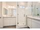 Modern bathroom featuring dual sinks, stone countertops, and a glass-enclosed shower at 106 Barkset Way, Henderson, NV 89011
