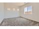 Spacious bedroom with plush carpeting, abundant natural light, and neutral color palette at 106 Barkset Way, Henderson, NV 89011