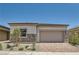 Charming single-story home with stone accents, manicured landscaping, and a brick driveway at 106 Barkset Way, Henderson, NV 89011
