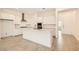 Bright kitchen featuring a large island, white cabinets, stone countertops and modern appliances at 106 Barkset Way, Henderson, NV 89011