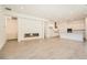 Open-concept living space with modern fireplace and gourmet kitchen with white cabinetry at 106 Barkset Way, Henderson, NV 89011
