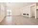 Bright living room featuring wood-look tile floors and modern fireplace at 106 Barkset Way, Henderson, NV 89011
