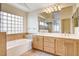 Bathroom with a large vanity, soaking tub, and a glass-enclosed shower at 1708 Jack Rabbit Way, Las Vegas, NV 89128