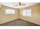 Charming bedroom with neutral walls, carpet flooring, and a ceiling fan at 1708 Jack Rabbit Way, Las Vegas, NV 89128