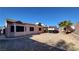 Backyard view of house with solar panels and covered patio at 1940 Whiton St, Las Vegas, NV 89156