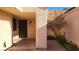 Covered side entrance with a dark brown door and small courtyard at 1940 Whiton St, Las Vegas, NV 89156