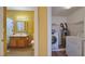 Open view of bathroom with nautical themed shower curtain, adjacent to laundry room with modern appliances at 2020 Rancho Lake Drive Dr # 205, Las Vegas, NV 89108