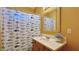Bright bathroom featuring a vanity with solid surface countertop, framed mirror, and a fish-themed shower curtain at 2020 Rancho Lake Drive Dr # 205, Las Vegas, NV 89108