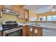 Well-lit kitchen featuring wood cabinets, stainless steel appliances, and white countertops at 2020 Rancho Lake Drive Dr # 205, Las Vegas, NV 89108