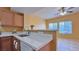 Bright, open kitchen with white countertops, wooden cabinets, and a view into the living area at 2020 Rancho Lake Drive Dr # 205, Las Vegas, NV 89108